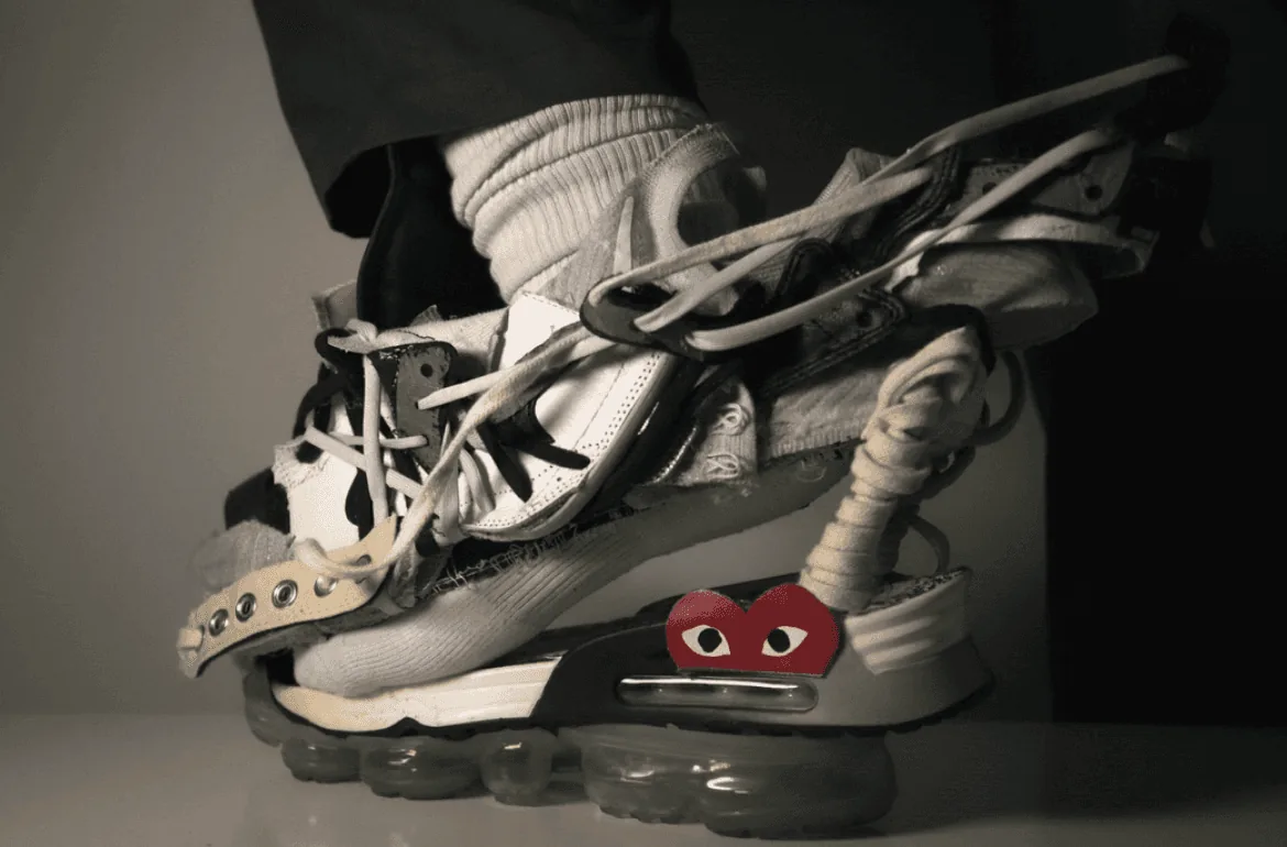 Concept fashion shoot of Nike sneakers encased in melting ice on a foggy rooftop