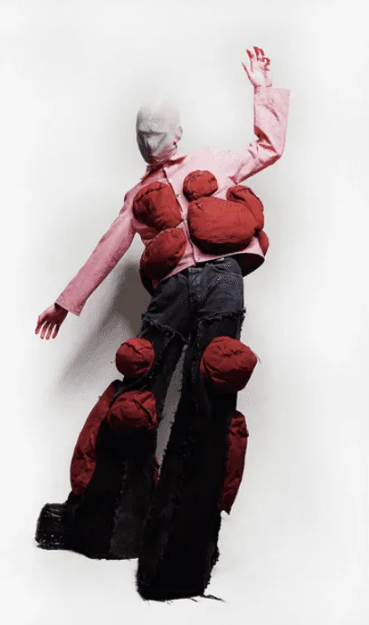 Student fashion look: pink jacket and dark denim sculpted with oversized red padded forms